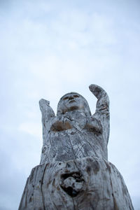 Low angle view of statue against cloudy sky