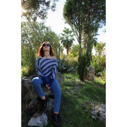 Portrait of young woman sitting outdoors