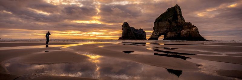 Scenic view of beach against sky during sunset