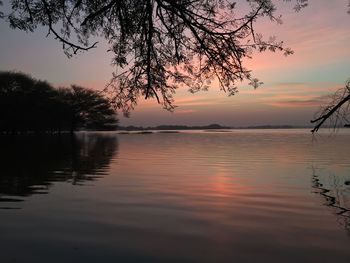 Scenic view of lake against sky at sunset