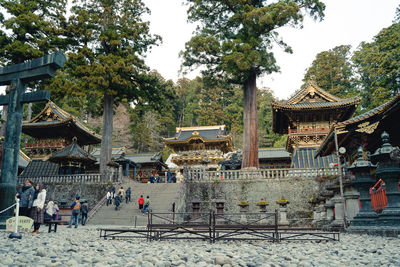 Group of people outside temple against building