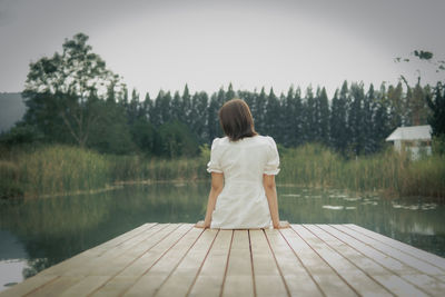 Rear view of woman looking at lake