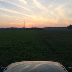 Scenic view of field against cloudy sky