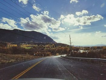 Road against sky seen through car windshield