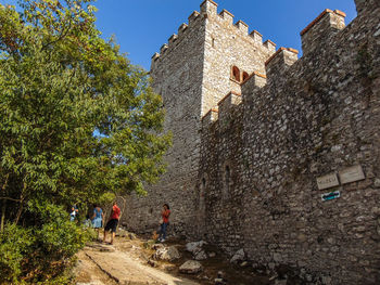 Low angle view of people on old building