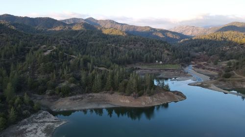 Scenic view of lake and mountains against sky