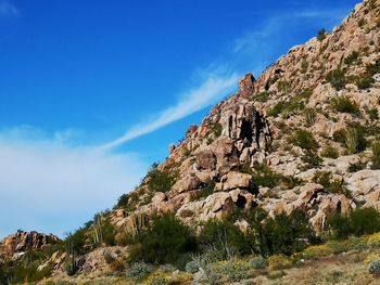 Low angle view of rock formation against sky