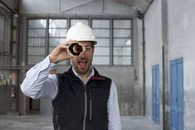 Man wearing hat standing at construction site