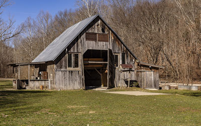 View of abandoned house on field