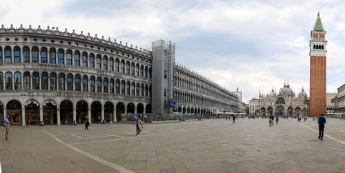 Group of people in front of historical building in city