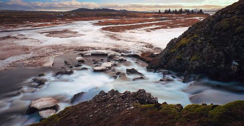 Scenic view of stream at pingvellir national park during winter