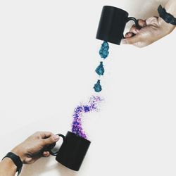 Cropped image of woman holding hands over white background