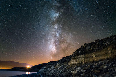 Scenic view of mountains against sky at night