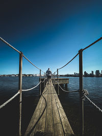 Bridge over sea against clear sky