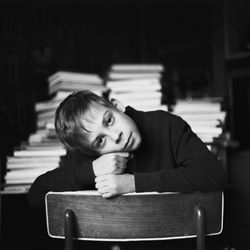 Portrait of boy sitting on table