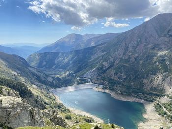 Scenic view of lake amidst mountains against sky