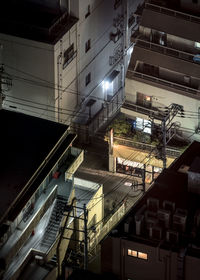 High angle view of illuminated buildings in city at night