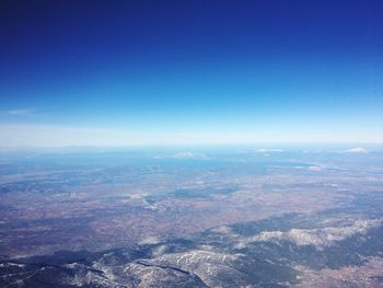 Aerial view of landscape against blue sky