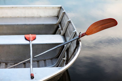 High angle view of oars in boat moored lake