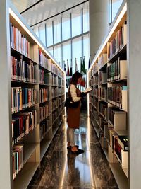 Side view of young woman reading book