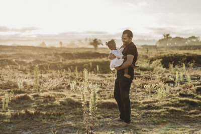 Full length of couple standing on field