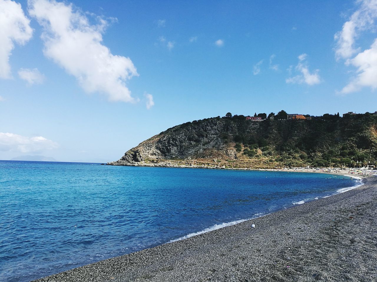 sea, water, sky, blue, horizon over water, scenics, tranquil scene, shore, tranquility, beauty in nature, nature, coastline, cloud - sky, cloud, vacations, rock formation, tourism, travel destinations, day, idyllic, outdoors, no people, remote, non-urban scene