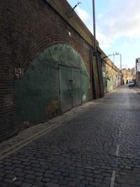 Empty road with buildings in background