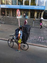 People riding bicycle on road