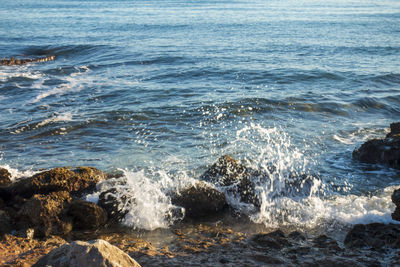 Waves splashing on rocks at shore