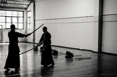 Silhouettes people against white wall