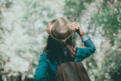 Close-up of woman wearing hat in forest