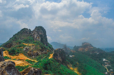 Scenic view of landscape against cloudy sky