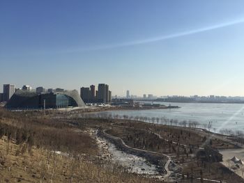 High angle view of lake in city against clear sky