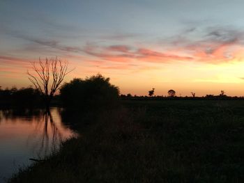 Scenic view of lake against sky during sunset