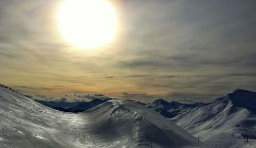 Scenic view of snow covered mountain against sky during sunset