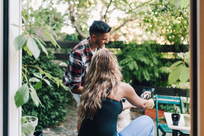 Rear view of couple kissing in park