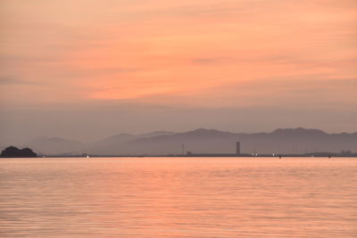 Scenic view of sea against romantic sky at sunset