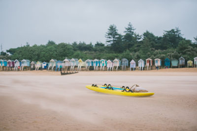 People at beach against sky