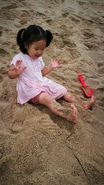 Happy girl on sand at beach
