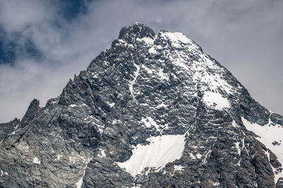 Low angle view of snowcapped mountain against sky