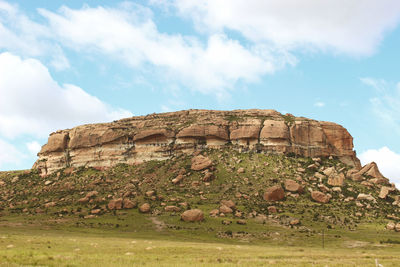 Low angle view of rocky mountain against sky