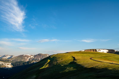 Scenic view of mountains against blue sky