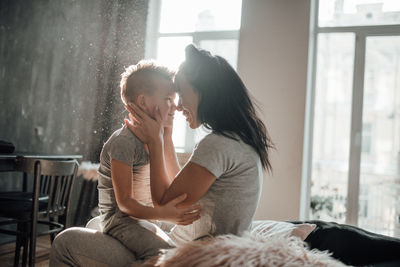 Friends sitting on window