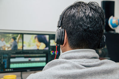 Rear view of man using mobile phone