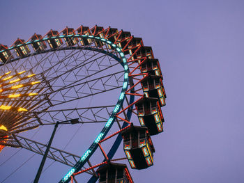 Low angle view of illuminated ferris wheel against clear sky