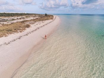 High angle view of man walking at beach against sky