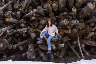 Portrait of a smiling woman sitting on rock