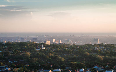 High angle view of buildings in city against sky