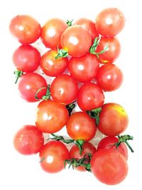 Close-up of red chili peppers on white background