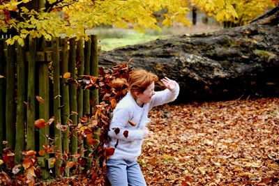 High angle view of girl standing at park during autumn